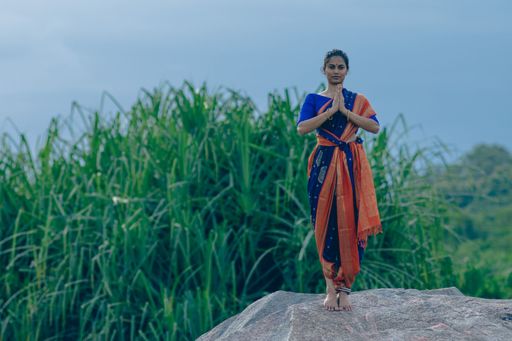 A yogini doing Asana in an ancient temple