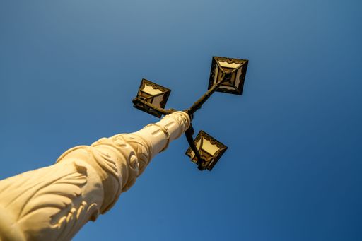 A low angle shot of the beautiful street lamp on a blue sky background