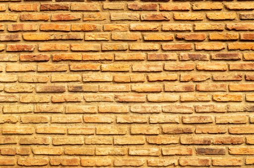 Seamless texture of weathered wall finish beige decorative brick. Stone Wall Pattern.