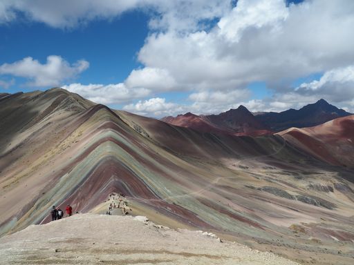 A low angle shot of the Rainbow Mountain in Uchullujllo Peru
