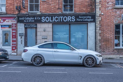 Dublin, Ireland - July 7 2022. A car parked in street of Dublin, in front of building during sunset, Ranelagh Road