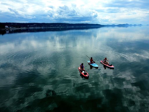 A group of Paddleboarders on the St Laurence lake under cloudy sky