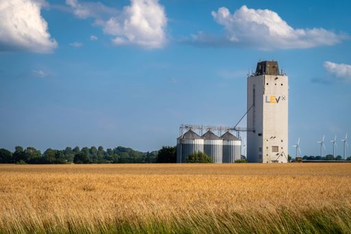 Germany,  Agricultural Silos - Building Exterior, Storage and drying of grains, wheat, corn, soy, sunflower against the blue sky with grain field