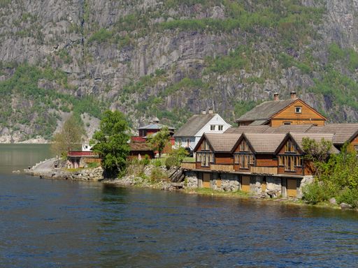 An aerial view of buildings surrounded by trees and water in Eidfjord
