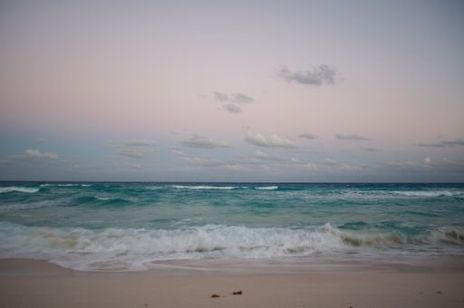 A breathtaking shot of the wavy ocean under the pure sky in the evening