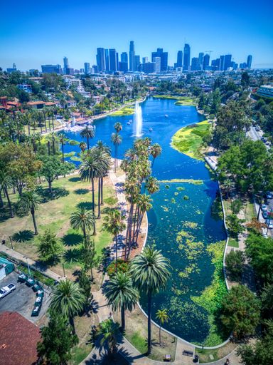 A vertical aerial view of the beautiful Echo Park Lake near the downtown Los Angeles skyline