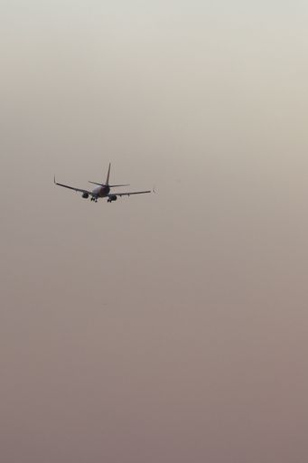 A vertical shot of a plane in the air during a sand storm