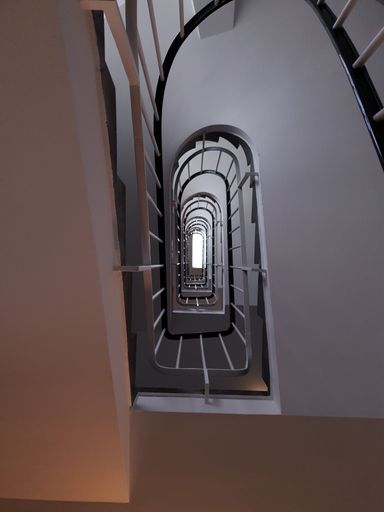 A low-angle shot of a spiral staircase of a building