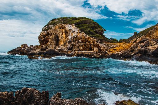 A river among rocky formations under cloudy sky