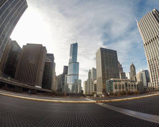 A low angle fish-eye shot of high skyscrapers in downtown Chicago under the breathtaking cloudy sky