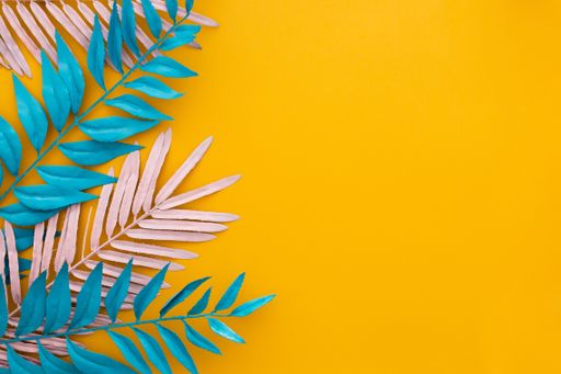 A high angle shot of blue and white decorative branches on a yellow background