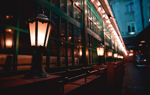 A closeup of lit lamps on a street in Chania at night