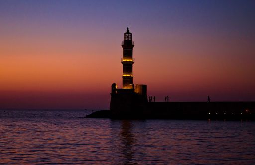 A beautiful shot of a lighthouse in Chania against a colorful sky during the sunset
