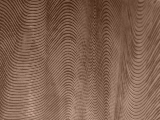 A closeup shot of a beige wall with a wavy pattern
