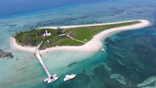 An aerial view of Isla de Enmedio with a pier and boats in the blue water, Veracruz Mexico