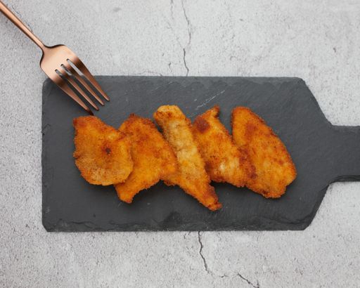 A top view of appetizing crispy fried chicken pieces with a fork