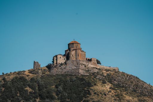 The Jvari Monastery on top of the hill under the blue sky in eastern Georgia