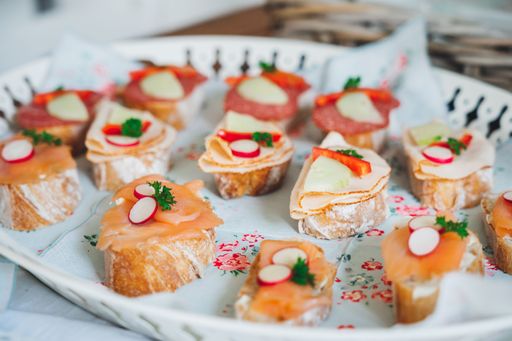 A closeup shot of small canapes arranged on a plate for an event