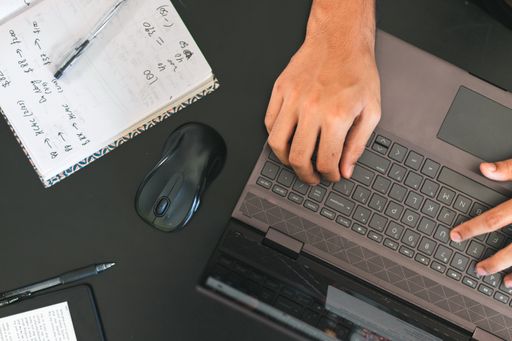 A high angle shot of male hands using a laptop