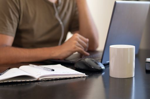 A closeup shot of male hands using a laptop