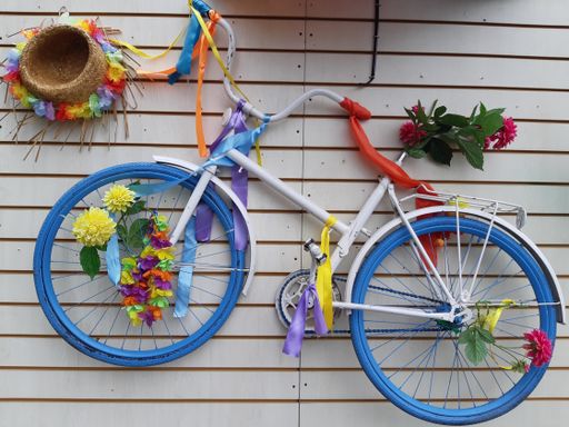 A closeup shot of a colorful bicycle hanging from a white wall