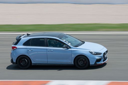 A sport car Hyundai i30 N in blue color running on the racing circuit