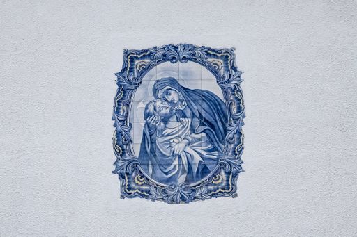 Azulejos in Portugal, detail on a typical house, blue religious scene
