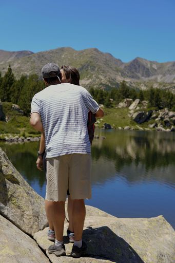 A couple kissing while standing by the lake