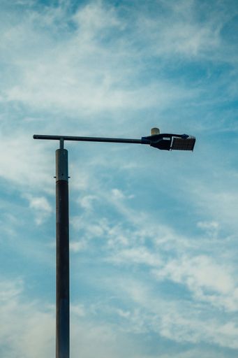 An isolated street light on a beautiful blue cloudy sky in the background