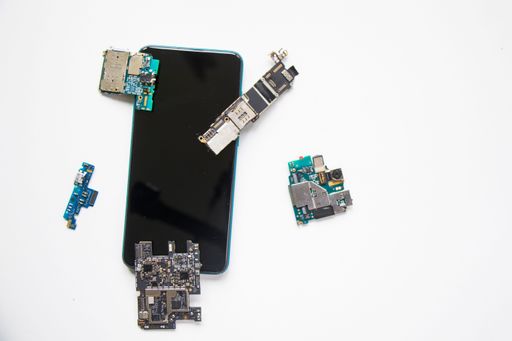 A closeup shot of a smartphone and its parts on the white background