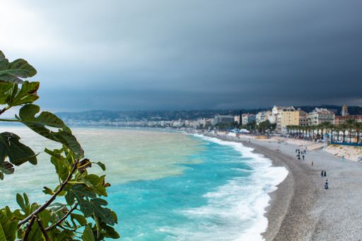 The wavy ocean hitting the sandy beach in Nice, France
