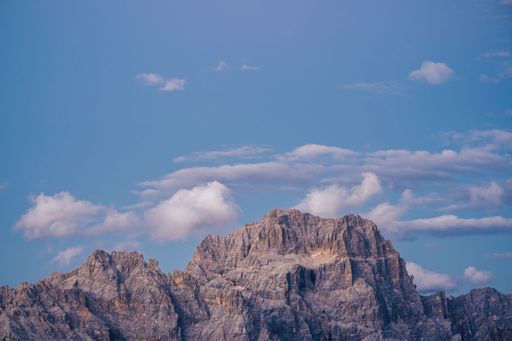 Sunset or sunrise over Punta Sorapiss, Dolomites, Tyrol, Italy. High alpine landscape with huge rock walls. Sunset light over rock face.