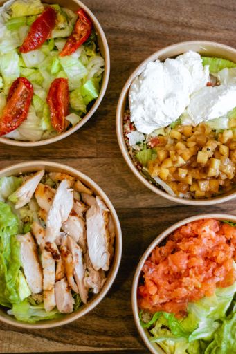 A vertical top view of the poke bowls with meat