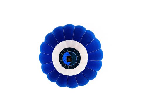 An isolated shot of a blue hot air balloon from below flying on a white background