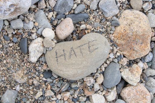 Heart Shaped Rock with "Hate" Written on it
