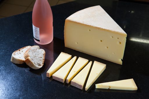 A closeup shot of French Gruyere cheese and baguette bread