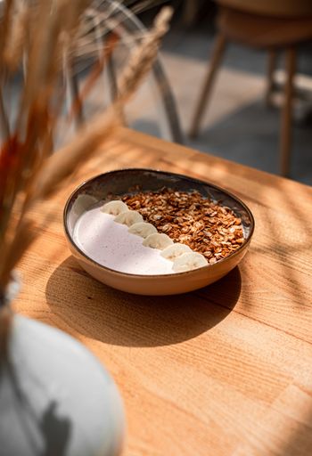 The vertical view of a bowl of cereal on the wooden table