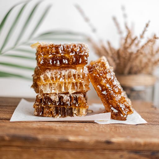 The close-up view of the honey combs on the wooden table