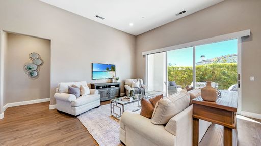 A luxury design of living room with white sofas, Glass Sliding Door, table, TV and white walls