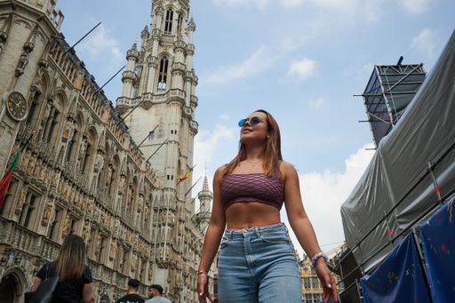 A low angle shot of a beautiful young female posing in the streets of Brussels