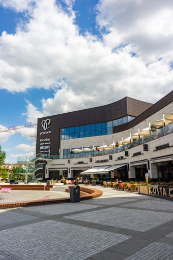 Exterior of the modern Posnania shopping mall building and a square on a warm summer day