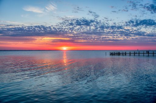 A beautiful shot of a seascape under the pink sunset and big clouds