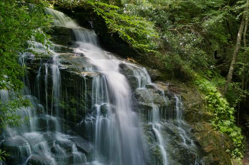 A long exposure of a small waterfall on the mossy rocks