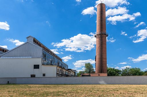 A landscape view of an abandoned factory on a sunny day
