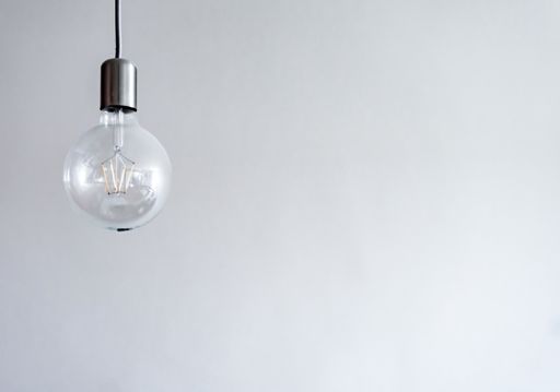 A retro big light bulb hanging on white background