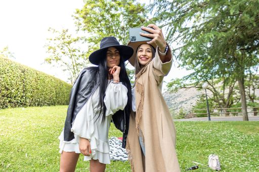 Affectionate young couple taking a self-portrait with a smartphone at the park
