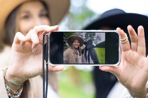 Affectionate young couple taking a self-portrait with a smartphone at the park