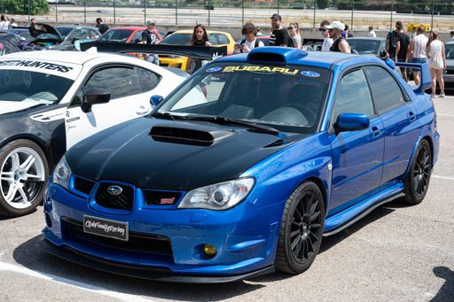 A Subaru Impreza second generation Hawkeye blue with black hood