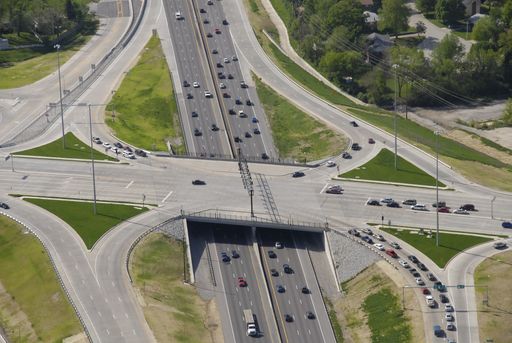 An aerial view of a major interstate highway cloverleaf and overpass in Missouri