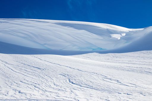 A mountain summit covered with a clean white snow